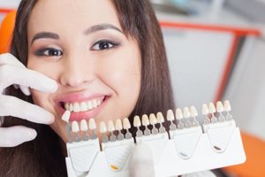 Smiling woman picking color for dental implants Queen Creek AZ