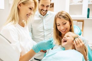 Kid and adults smiling at the family dentist queen creek az prefers