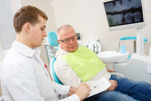 man wondering if he needs dentures or dental implants