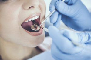 Tooth extractions start with checking teeth with instruments