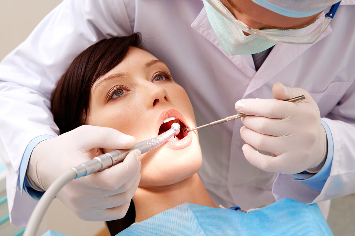 gum disease symptoms Woman receives care for her gum disease symptoms