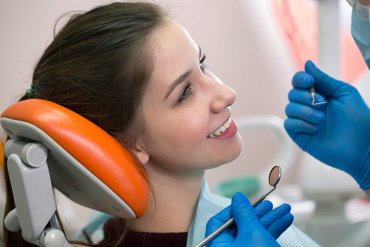 relieve tmj symptoms Smiling patient learns how she can relieve TMJ symptoms